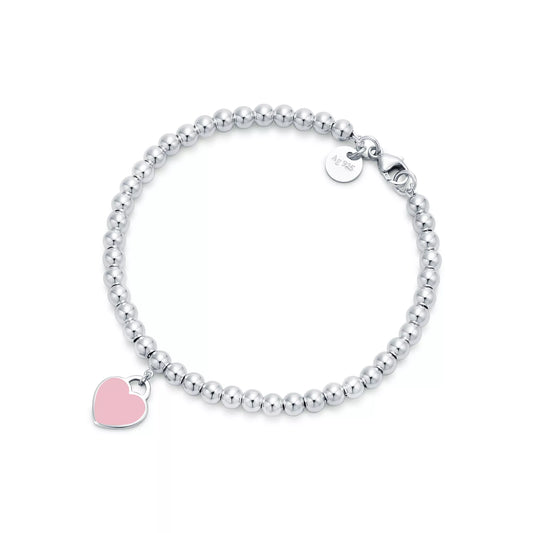 Tiffany & Co.: Pink Mini Heart Bead Bracelet in Silver with a Diamond, 4 mm